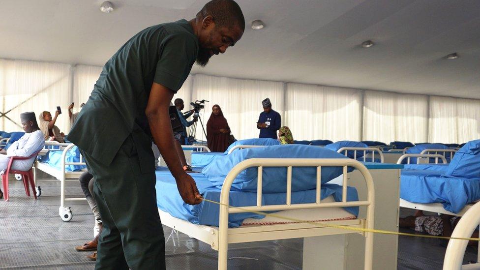 A man makes a bed in hospital