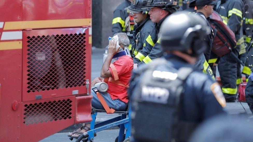 An injured person is taken away in a wheelchair after a car accident in New York