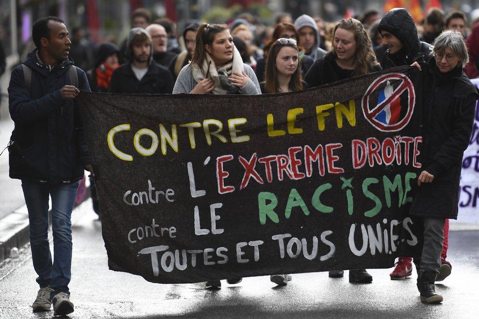 Militants hold a banner "against FN, far-right, racism" in Rennes, western France, 26 April