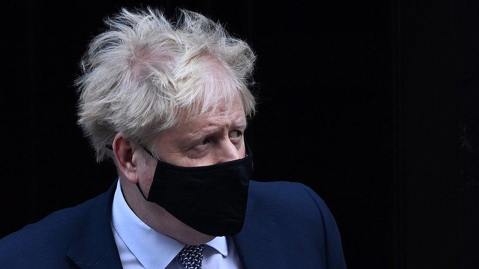 Boris Johnson in a mask leaving No 10