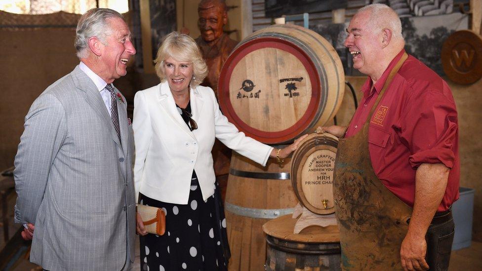 Prince Charles and the Duchess of Cornwall speak with a worker during a visit to Seppeltsfield Winery in the Barossa Valley, Australia