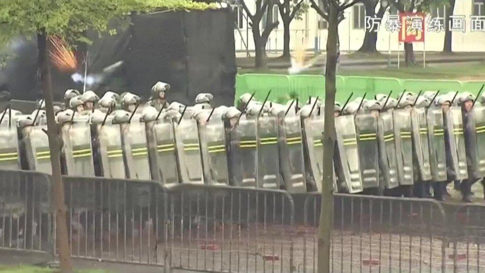 Screen grab from the PLA's anti-riot video - shows lines of riot police with shields and batons