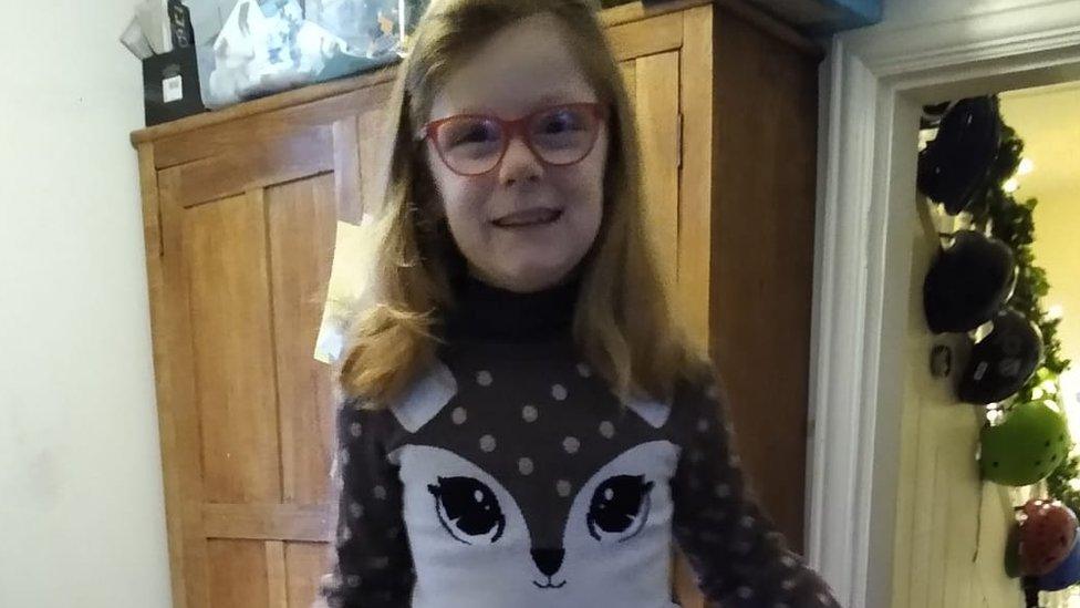 Girl in Christmas jumper.
