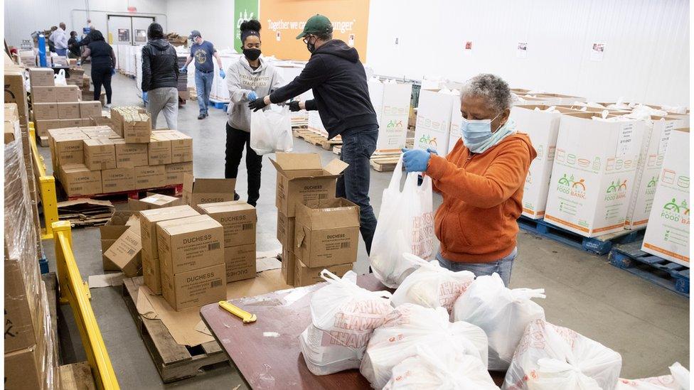 Volunteers prepare food items that will be donated to those in need at Capital Area Food Bank (CAFB) in Washington, DC, USA, 05 February 2021.