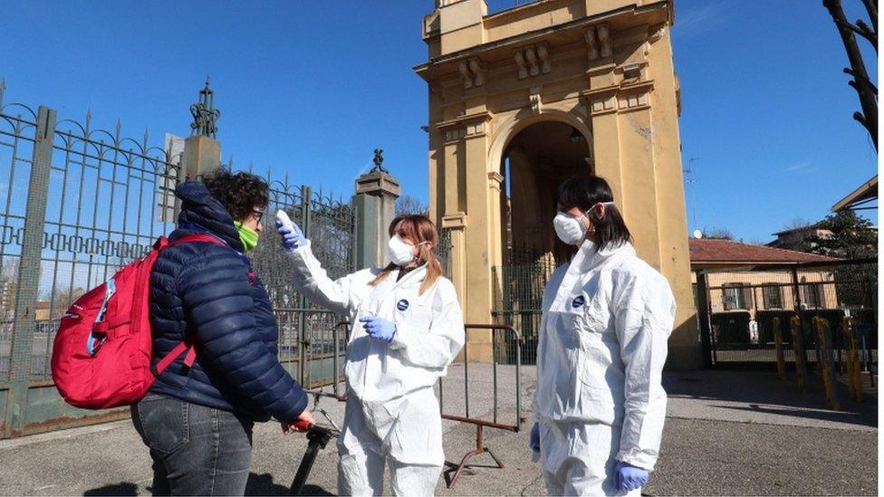 Health personnel carry out body-temperature checks on staff members entering the Tardini stadium in Parma ahead of the Parma Calcio vs S.P.A.L football match in Parma, Italy, 8 March 2020