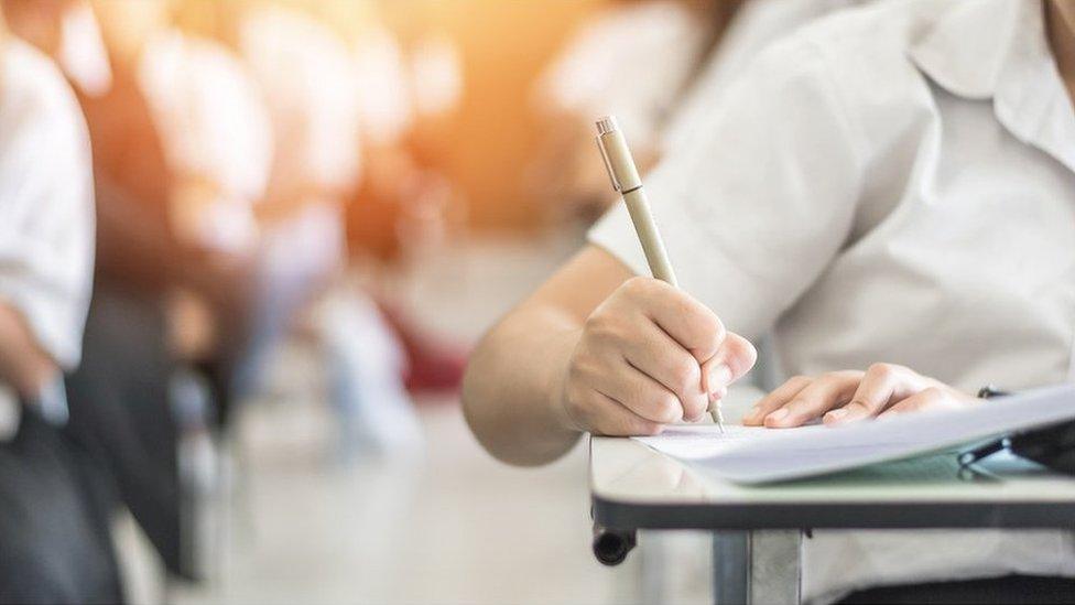 A school child with pencil and notebook