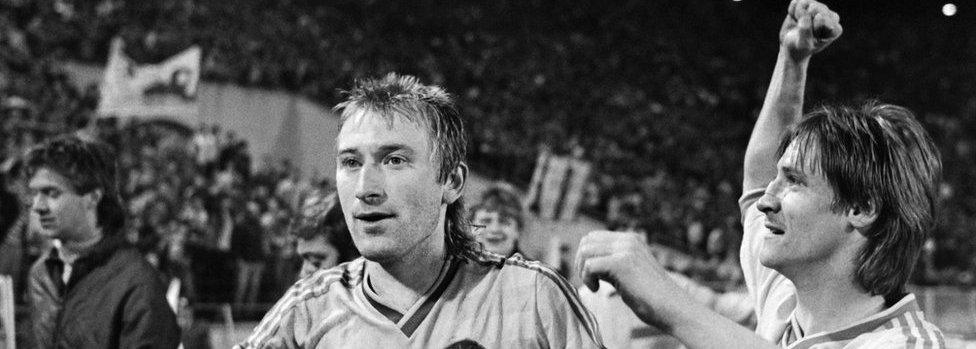 Leipzig's Matthias Liebers (L) and Ronald Kreer (R) celebrate their victory at the end of the semi final between Bordeaux and Lokomotiv Leipzig, on April 22, 1987, in Leipzig