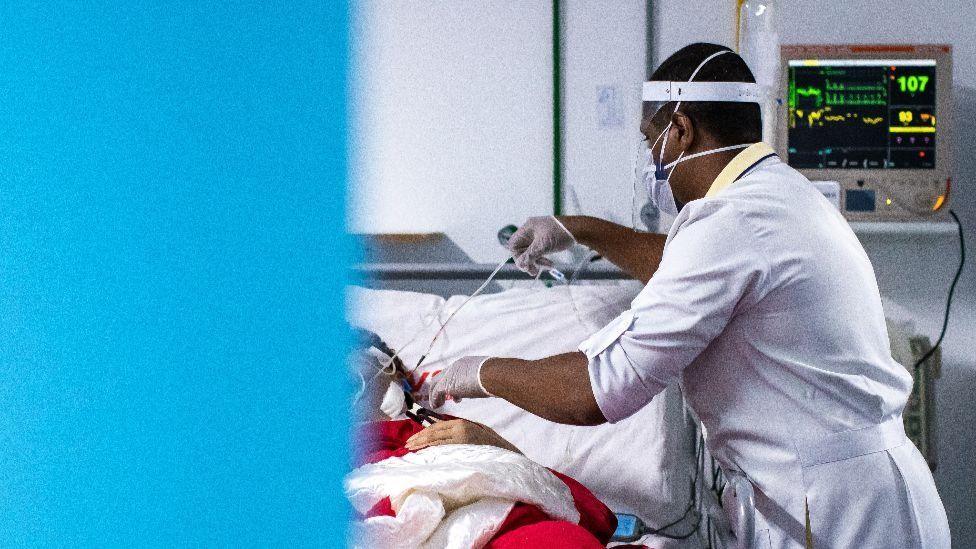 A nurse cares for a Covid-19 patient at a hospital in Rio de Janeiro state, May 2020