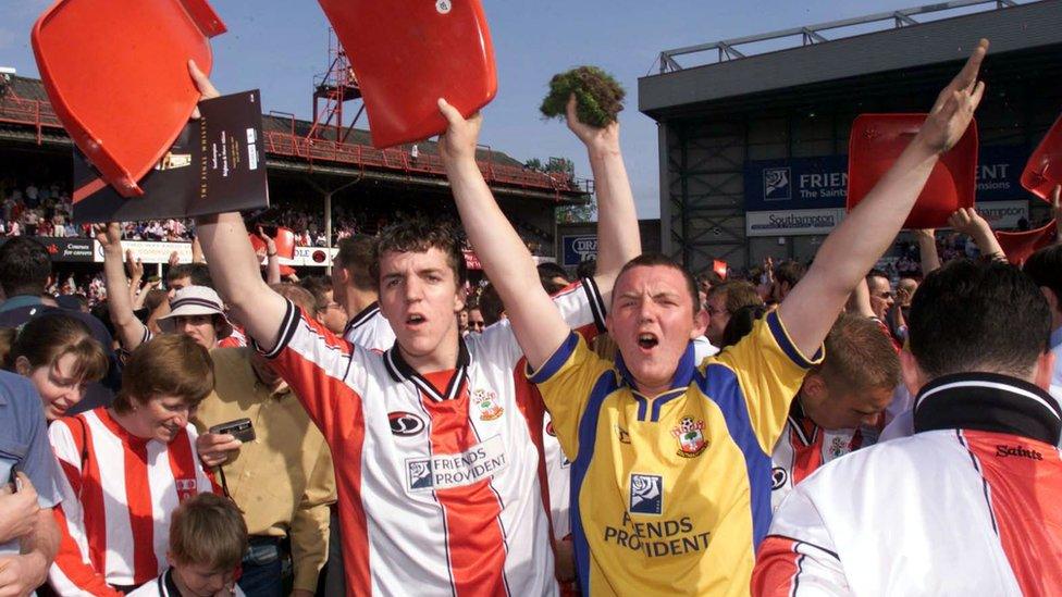 Saints hold aloft seats and turf following the final game at The Dell