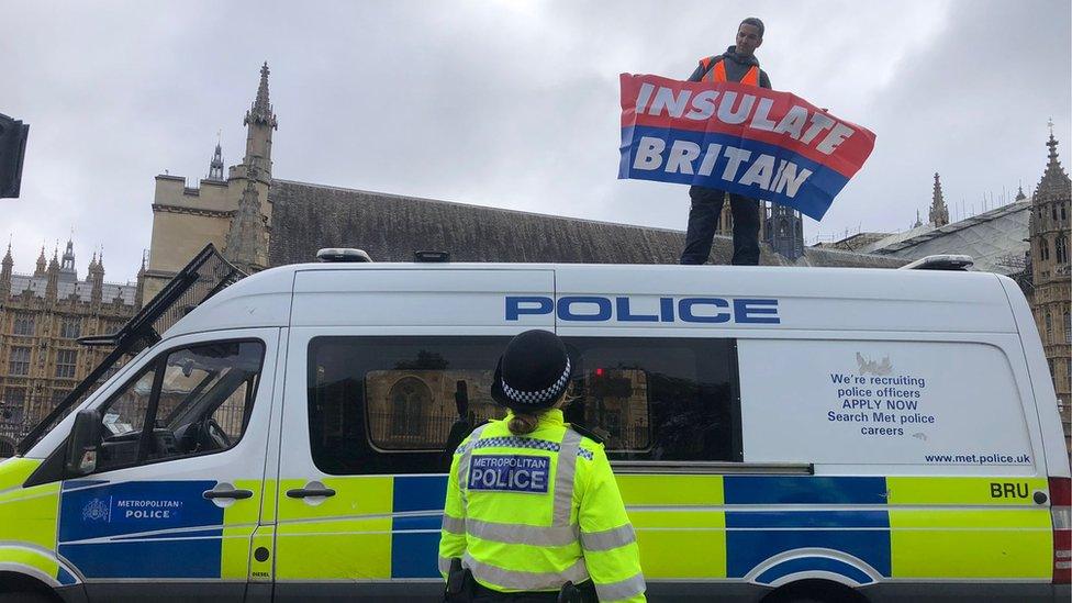 Protester on police van