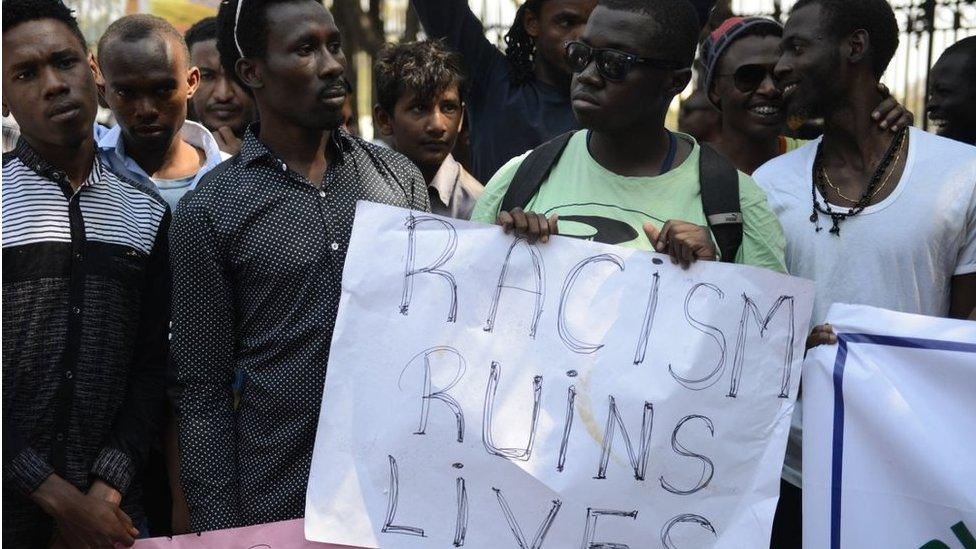 Members of the African Students Association hold placards during a protest in Hyderabad on February 6, 2016