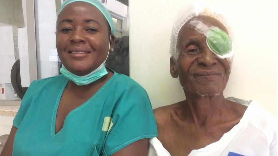 A member of staff with a patient at Oshakati hospital