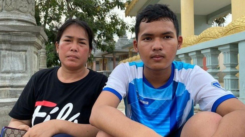 Prum Chantha and her son sit at a Buddhist temple in Phnom Penh