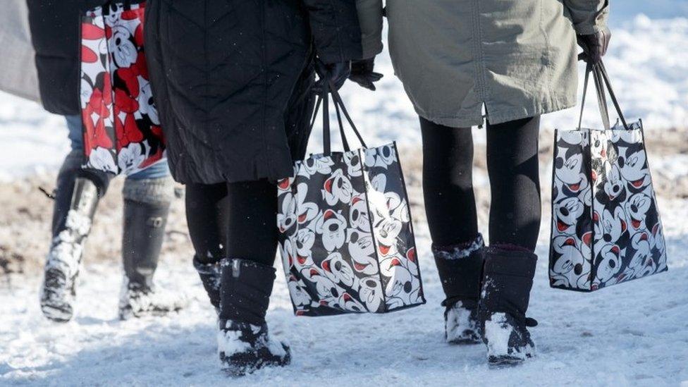 Shoppers waling in the snow