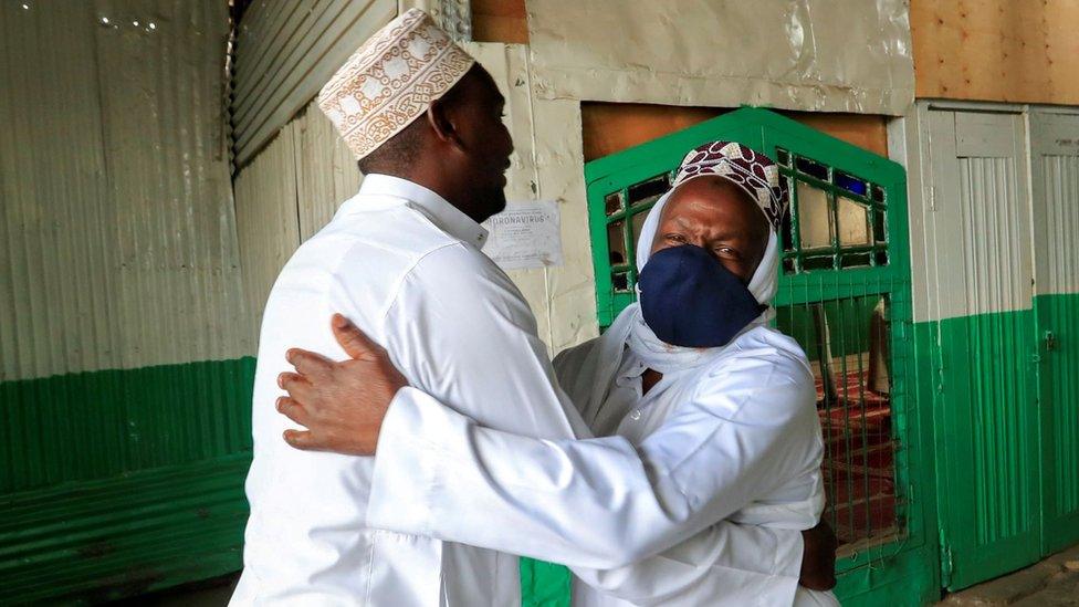 Muslim faithful embrace before performing the Eid al-Fitr prayers, marking the end of the holy fasting month of Ramadan, outside a mosque closed amid concerns about the spread of the coronavirus disease (COVID-19), in Nairobi, Kenya, May 24, 2020.