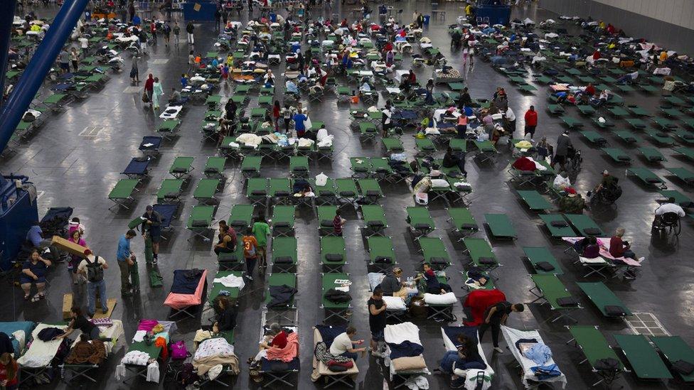 An emergency shelter with many beds in Houston.