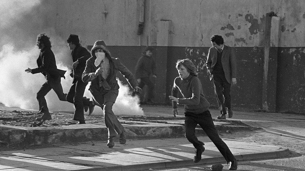 Young Catholic rioters hurl projectiles in Londonderry in March 1972