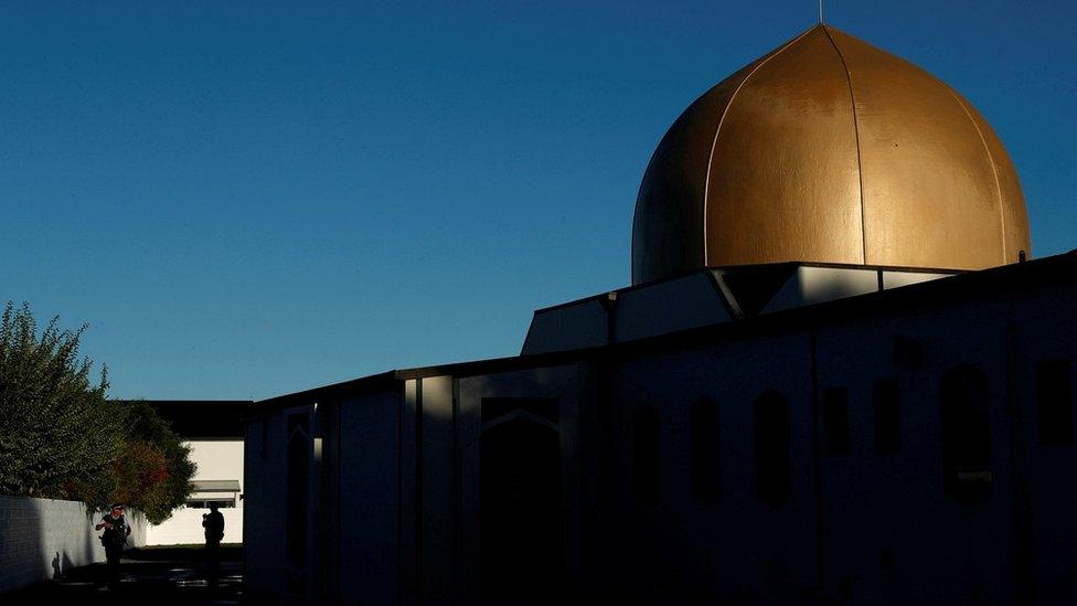 Armed police officers stand guard outside Al Noor mosque where more than 40 people were killed by a suspected white supremacist