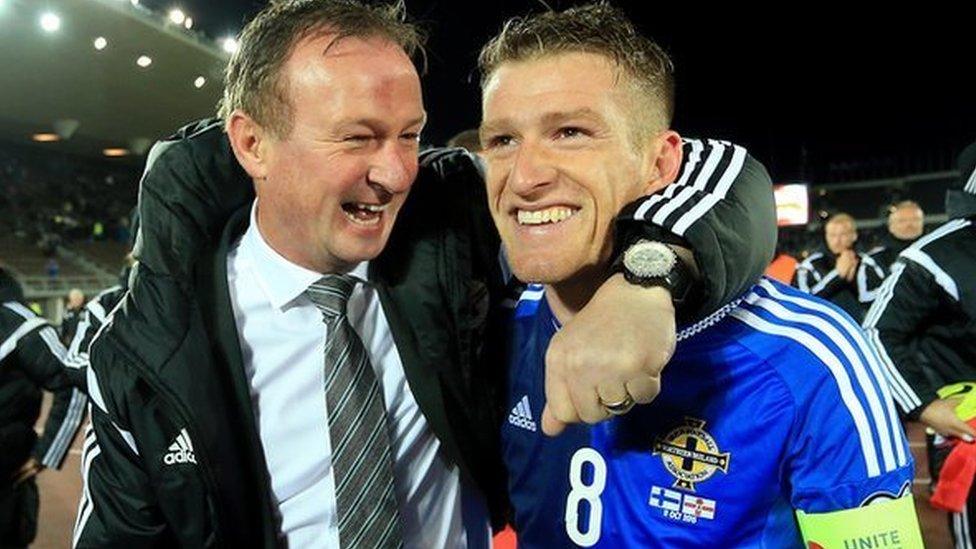 Michael O'Neill celebrates with Steven Davies