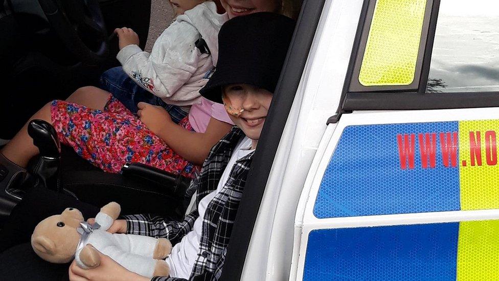 Image of Lexi-May in police car