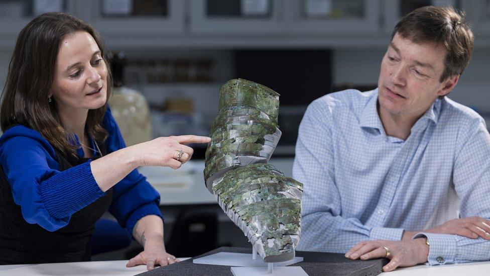 bethan bryan and dr fraser hunter look at the armour together on display