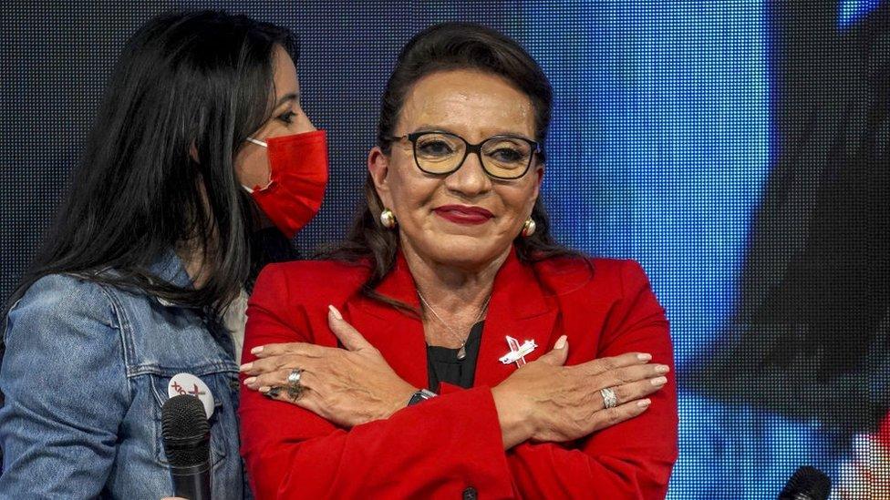 Honduras president Xiomara Castro gestures to a crowd with an embrace.