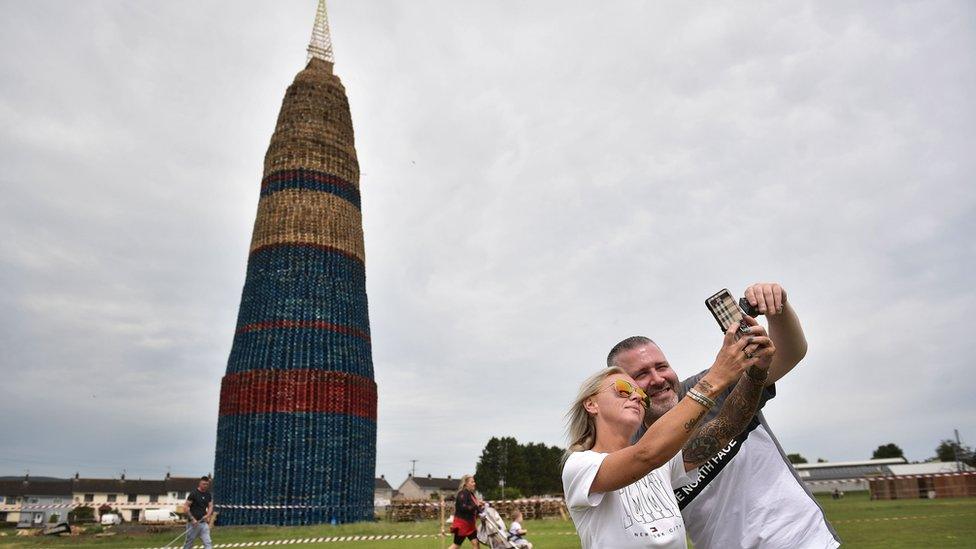 Man and woman take a selfie at bonfire