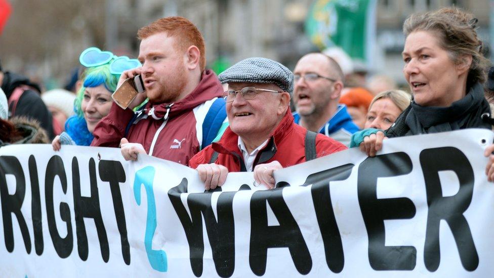 Demonstrators hold a banner against water charges during a march and rally organized by Right2Change and Right2Water in Dublin, Ireland, on February 20, 2016