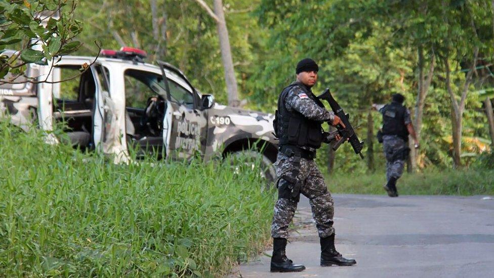 Military police officers track for fugitives of the Anisio Jobim Penitentiary Complex after a riot in the prison left at least 60 people killed and several injured, in Manaus