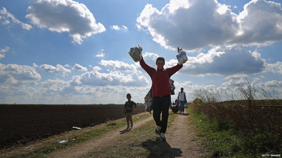 Migrants cross the border from Serbia into Hungary