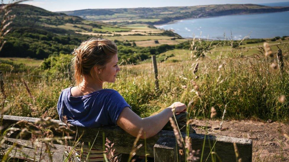 Woman sitting on a bench in Ravenscar