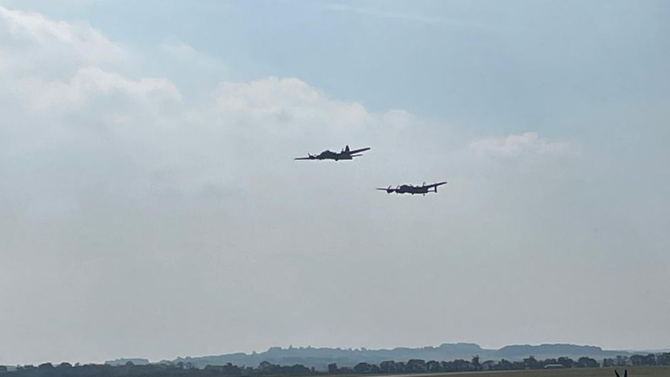 Two planes fly overhead at the air show