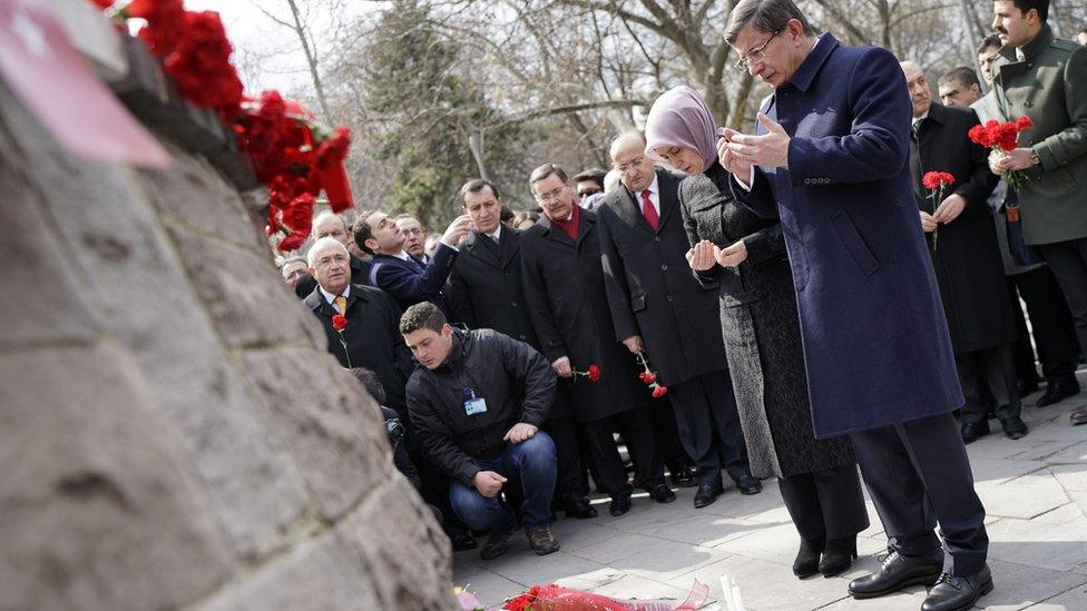 Turkish Prime Minister Ahmet Davutoglu and his wife Sare pray at scene of attack in Ankara. 17 March 2016