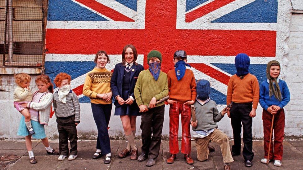 Children from a Loyalist area in Belfast in front of a Union Jack flag mural in 1971