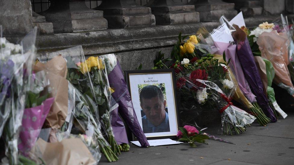 Flowers and a photo of killed police officer Keith Palmer