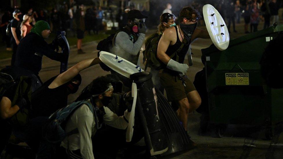 Protesters hold up make-shift shields during unrest in Kenosha