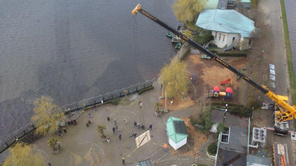 Banksy artwork being lifted by crane