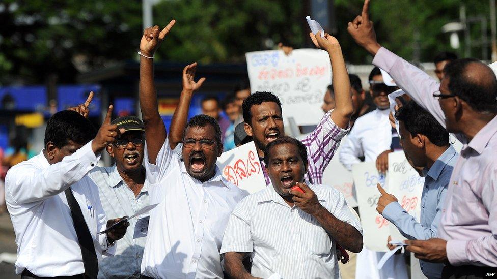 Sri Lankan political activists stage a demonstration denouncing attempts by former president Mahinda Rajapaksa's to contest upcoming parliamentary elections in Colombo on July 3, 2015.