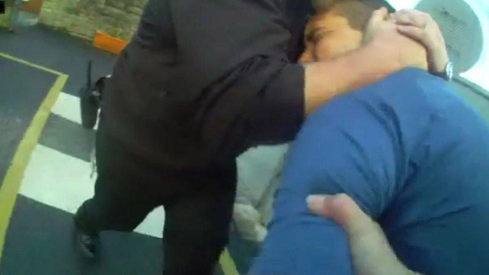 Michael Smith being restrained