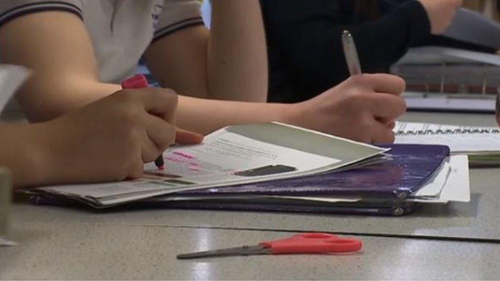 School children writing in class