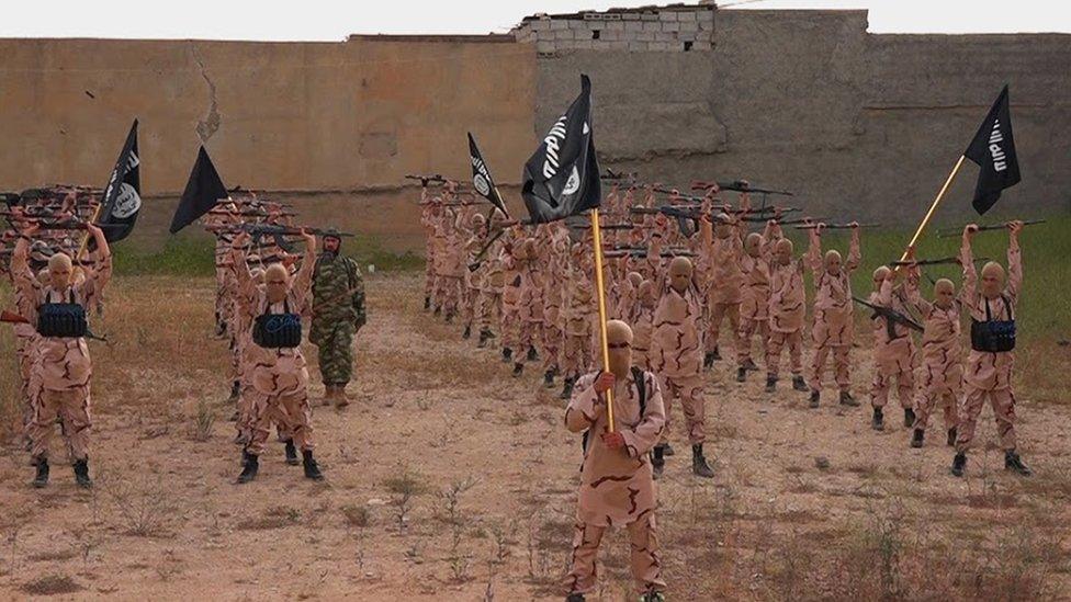 Image purportedly showing young boys known as the "lion cubs" holding rifles and Islamic State flags as they exercise at an IS training camp in Tal Afar, northern Iraq (27 September 2015)