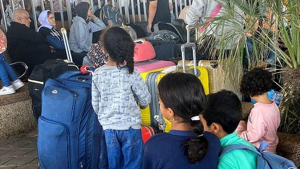 Palestinians with dual citizenship wait at the Rafah border crossing with Egypt, in the hope of getting permission to leave Gaza, amid the ongoing conflict between Israel and Palestinian Islamist group Hamas, in Rafah in the southern Gaza Strip, November 1, 2023