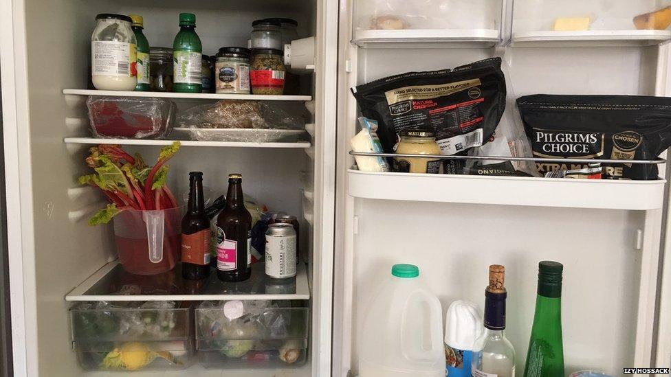 An open fridge with food and drink inside.