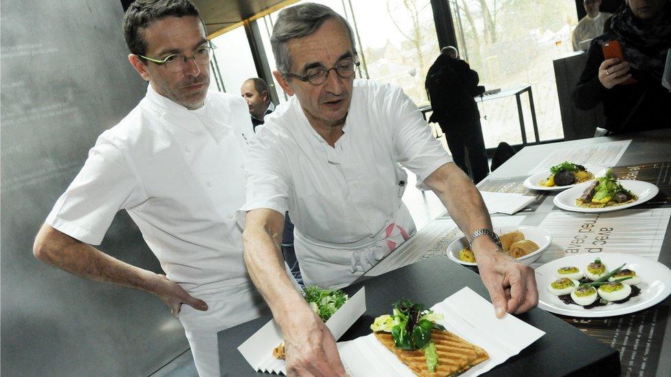 French chef Michel Bras and his son Sebastien present a dish at Bras' new restaurant in the Soulages museum in Rodez, southern France, on 25 March 2014