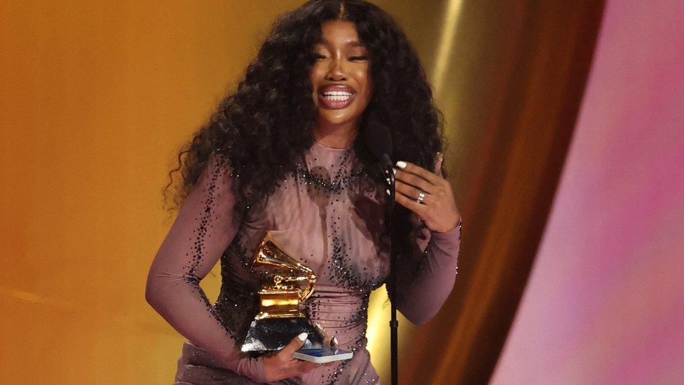 SZA accepts the award for Best R&B Song for Snooze during the 66th Annual Grammy Awards in Los Angeles