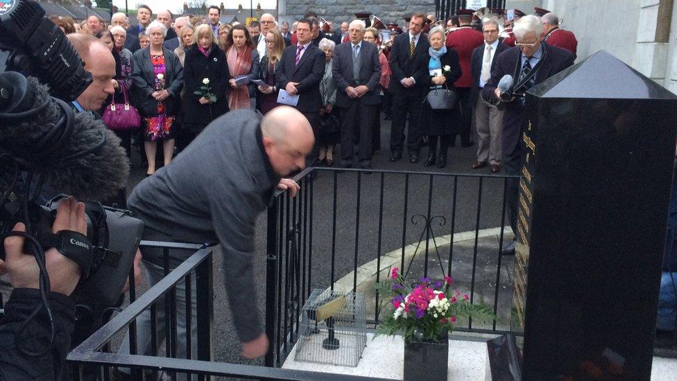 Laying flowers at the memorial