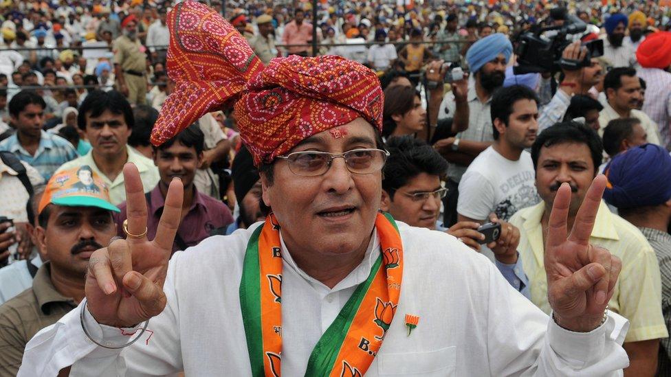 Opposition Bharatiya Janata Party (BJP) candidate for Gurdaspur and Indian film actor Vinod Khanna makes a victory sign during an election campaign rally on the outskirts of Gurdaspur on April 24, 2009.