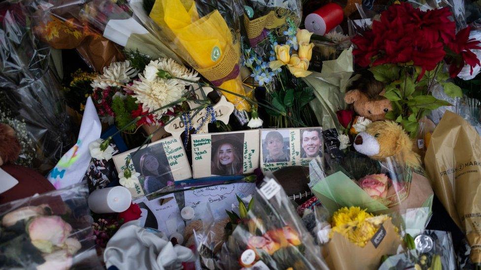 Photos of the victims from last weeks shooting are seen at the memorial outside of Oxford High School on December 7, 2021 in Oxford, Michigan