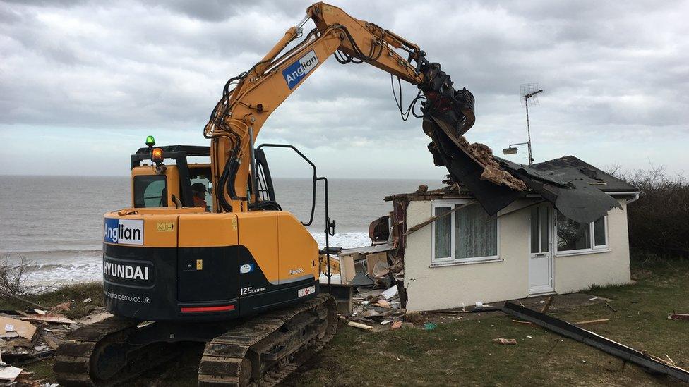 Digger demolishing chalet