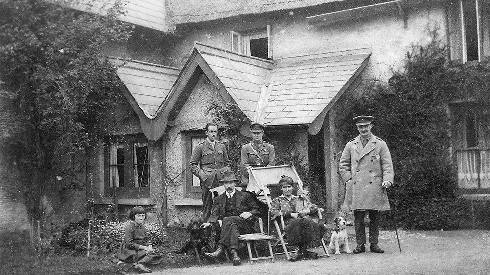 A group of officers, including the squadron commander Major D.G.Joy with the Scott family, posing outside Strathroy House